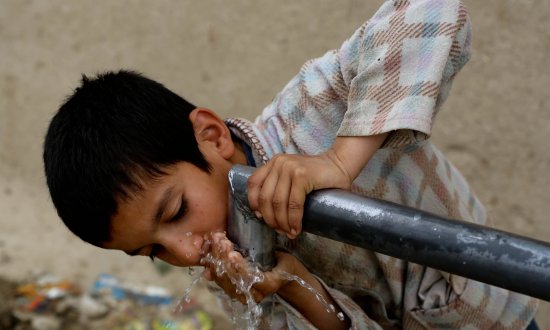 Boy drinking water Afghanistan