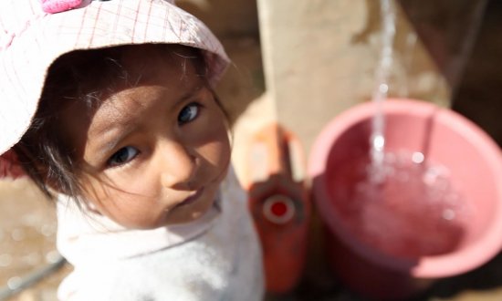 Child at public water station