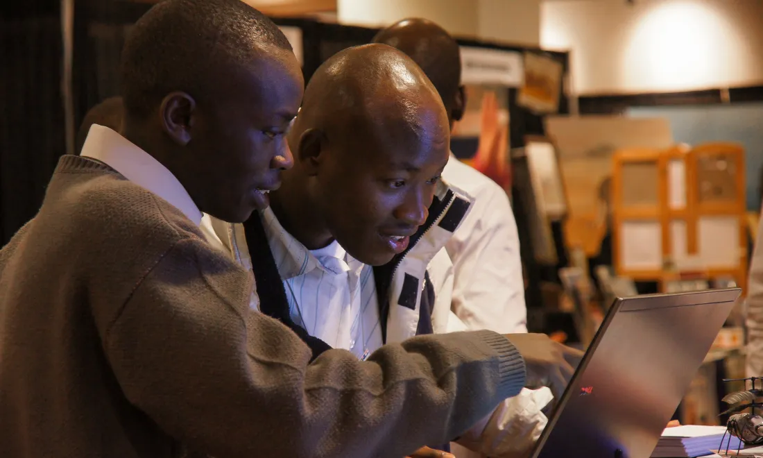 Two men looking at laptop
