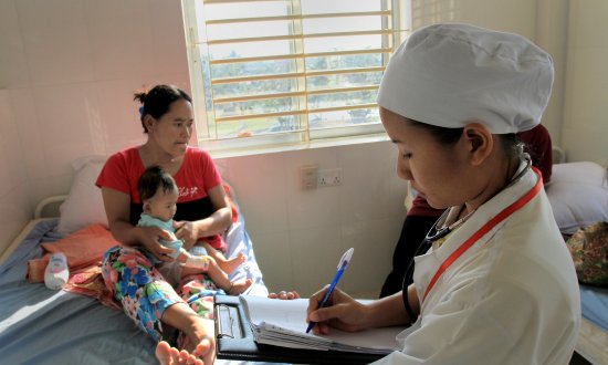 Health worker with mother and child