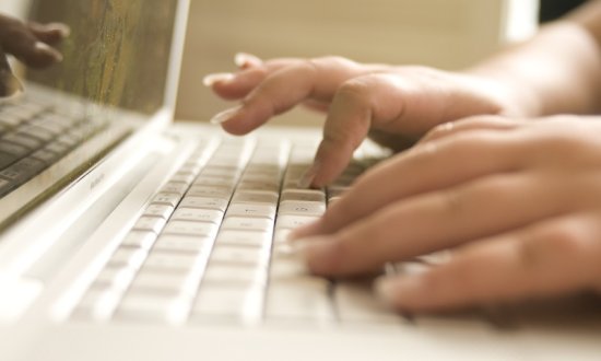 hands typing in Computer