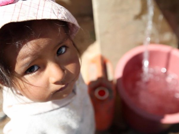 Child at water station Bolivia. 