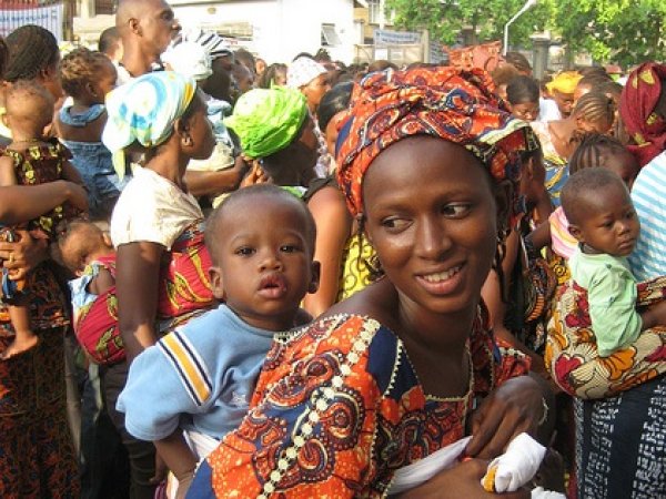 Woman carrying child on her back