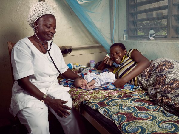 Nurse with mother and babay, Benin, 