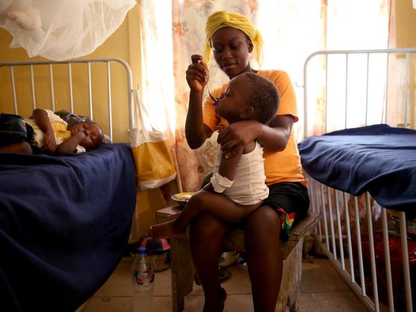 Woman feeding child in hospital, Liberia