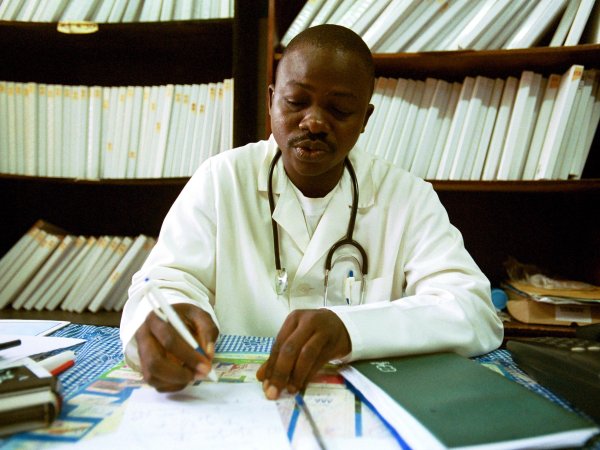 Doctor_ at desk writing