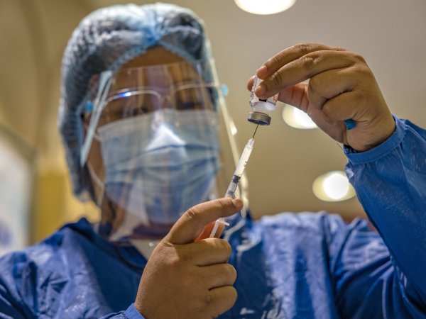 health worker preparing vaccine 