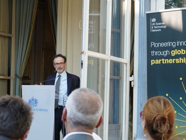 Philippe Guerin speaks from podium to an audience
