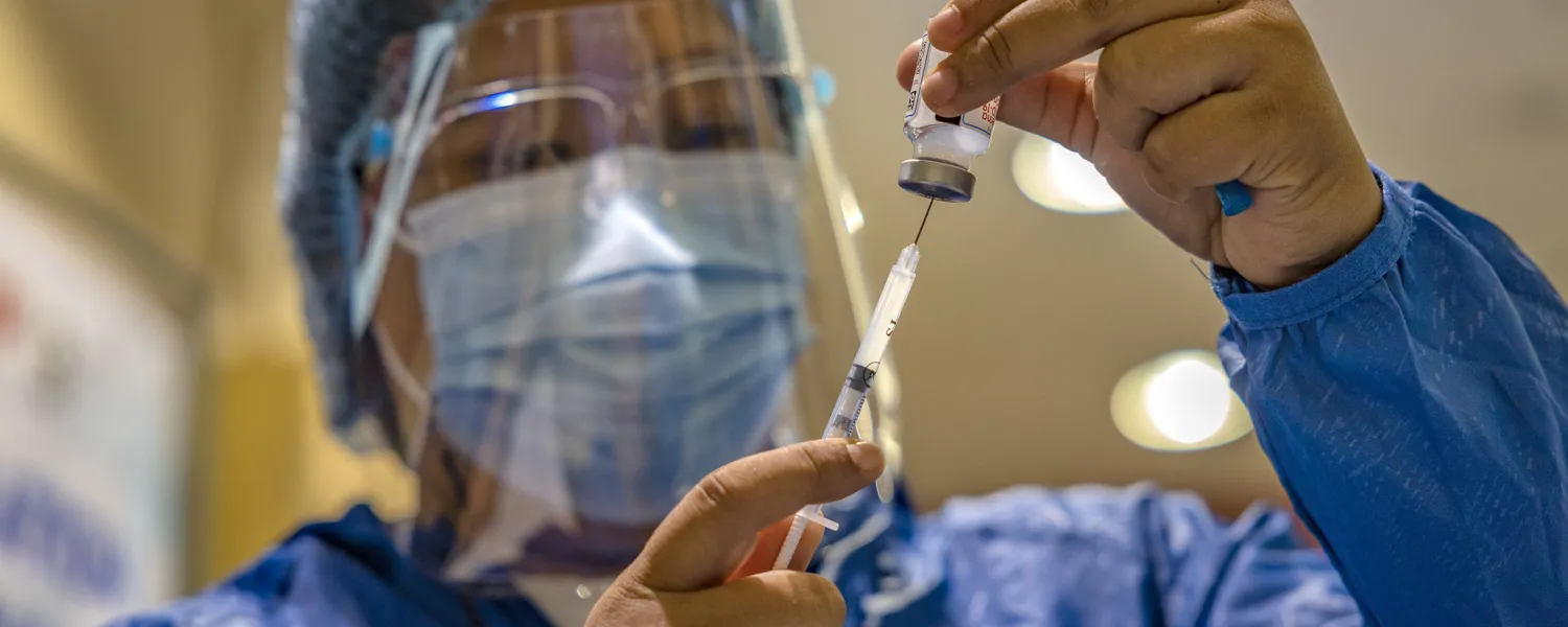 health worker preparing vaccine 