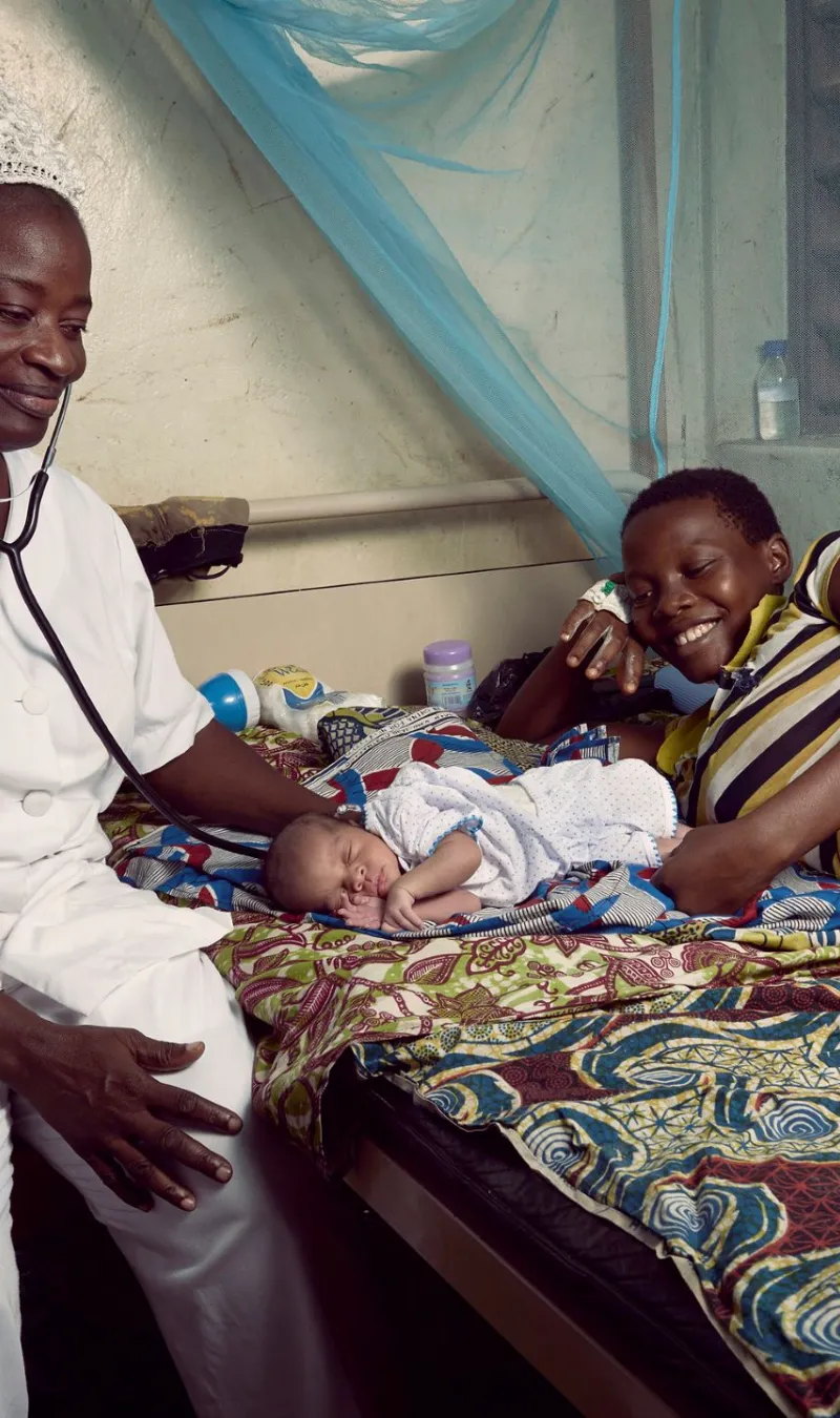 Nurse with mother and babay, Benin, 