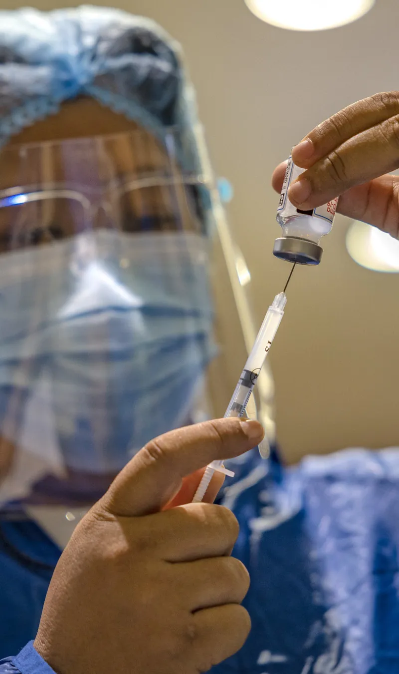 health worker preparing vaccine 