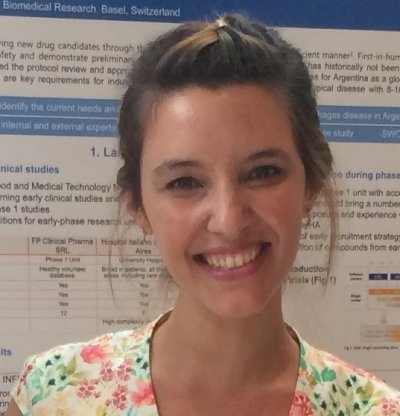 Photo of smiling woman in front of scientific poster