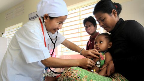 medic examines infant