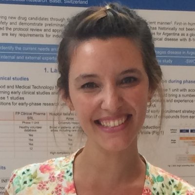 Photo of smiling woman in front of scientific poster