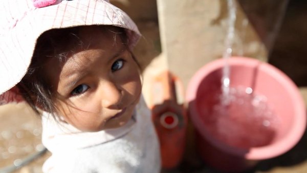 Child at water station Bolivia. 