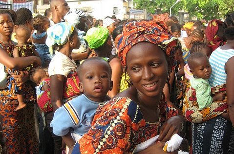 Woman carrying child on her back