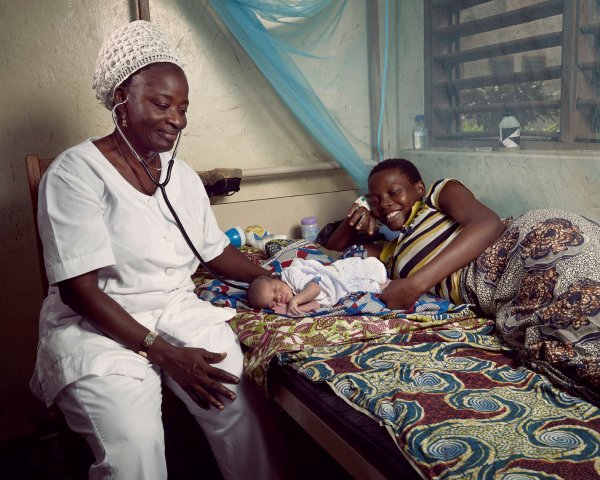 Nurse with mother and babay, Benin, 