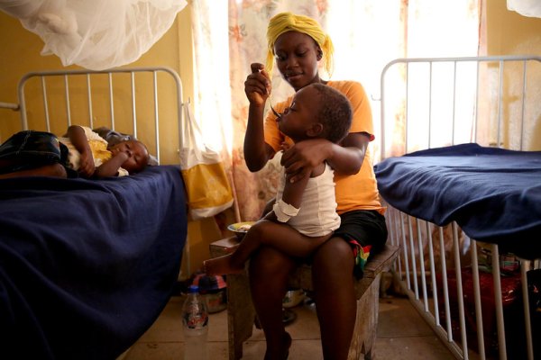 Woman feeding child in hospital, Liberia