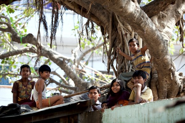 Children sitting under tree in region of India