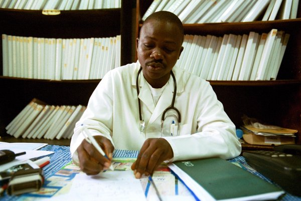 Doctor_ at desk writing
