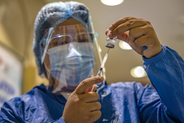 health worker preparing vaccine 