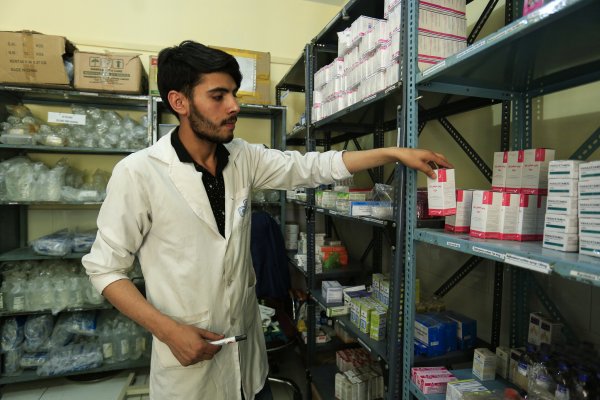 Health worker sorts prescriptions