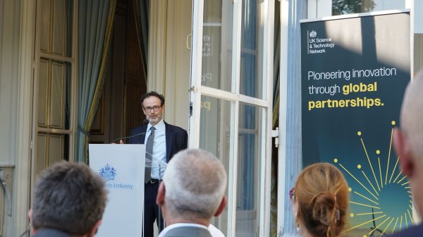 Philippe Guerin speaks from podium to an audience