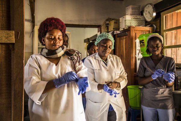 Photo of health care workers putting on gloves