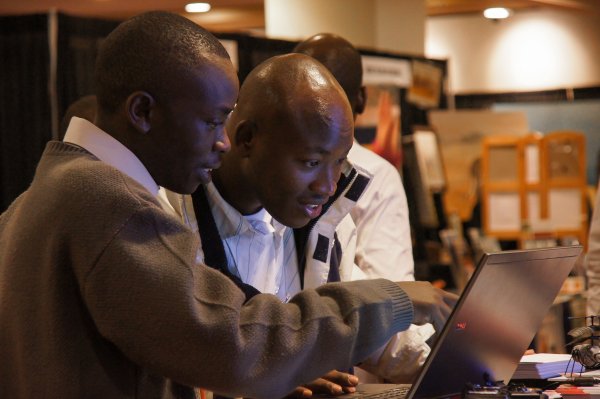 Two men looking at laptop