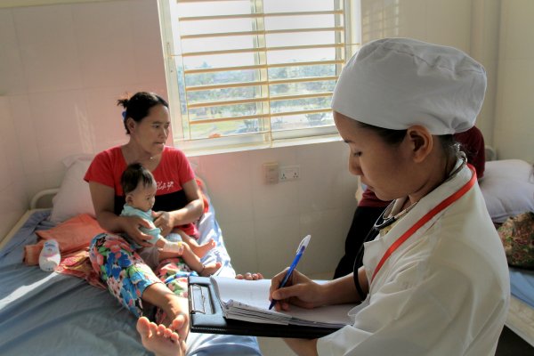 Health worker with mother and child