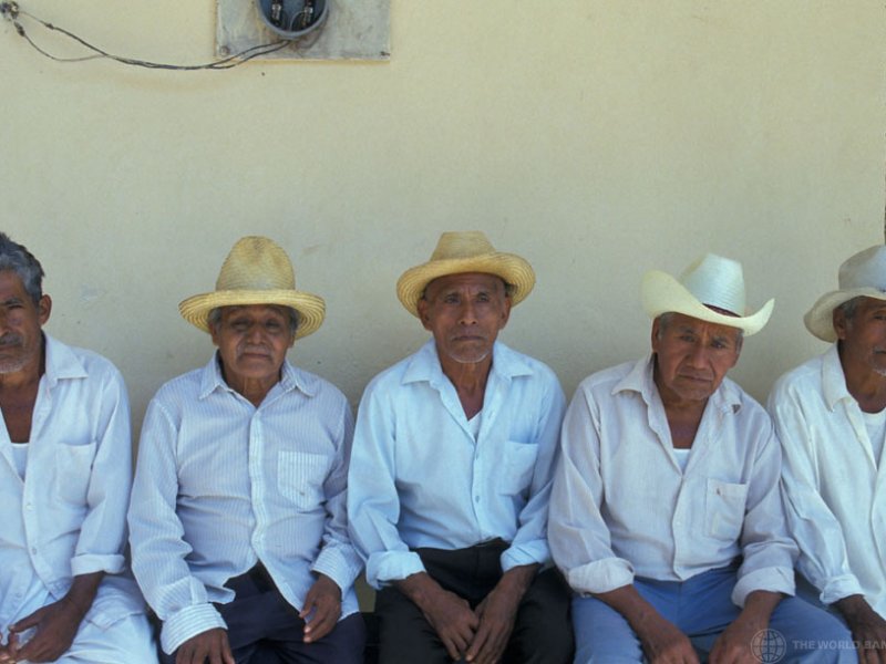 Farmers sitting on a bench, Mexico. Credit Curt Carnemark, World Bank