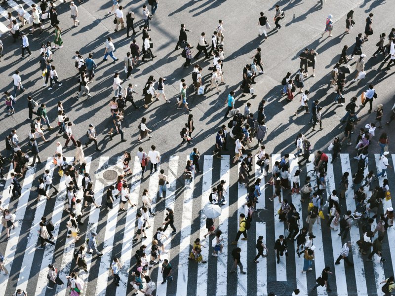 Photo of busy road crossing with pedestrians