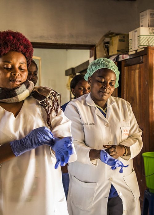 Photo of health care workers putting on gloves